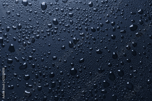 Blue surface with shiny water drops, background