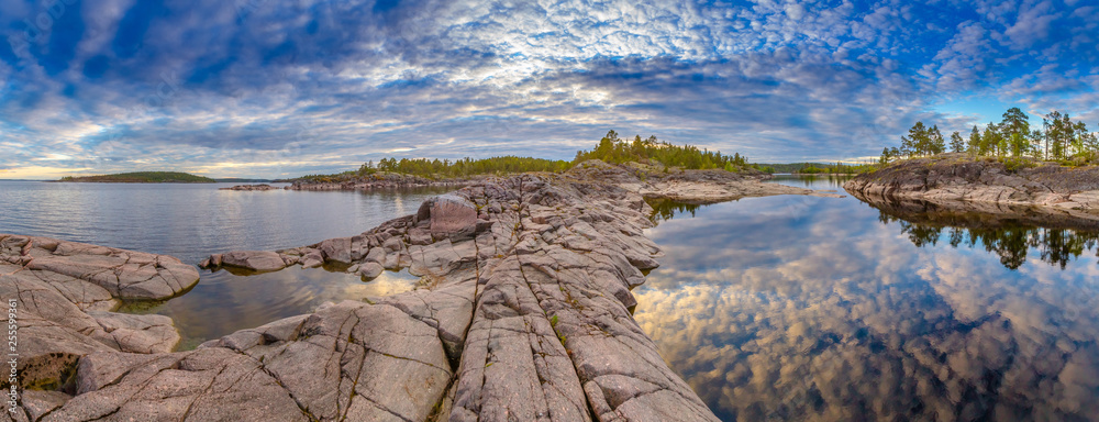 Stones in the water. Rocky shore. Nature of Karelia. Rocks on the shore of Lake Ladoga. Travel to Russia. Republic of Karelia. Islands. Northern nature. Skerries in Lake Ladoga. Panorama of Karelia. Stones in the water. Rocky shore. Nature of Karelia. Rocks on the shore of Lake Ladoga. Travel to Russia. Republic of Karelia. Islands. Northern nature. Skerries in Lake Ladoga. Panorama of Karelia.