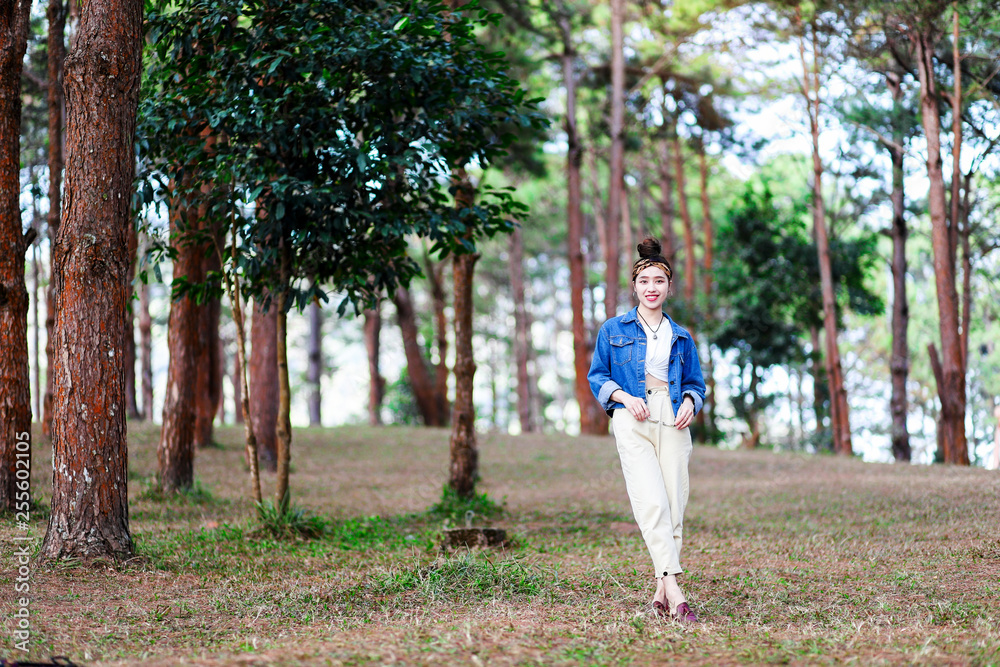 Beautiful Asian woman in the pine wood