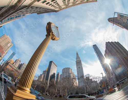 Cast iron street clock on fifth avenue, madison square. Wide angle shot with flatiron and skyline, New York, USA