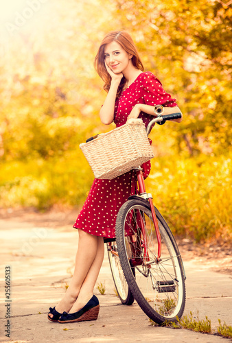Beautiful girl with bike at countryside.