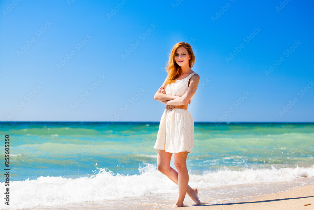 Young redhead girl at the beach.