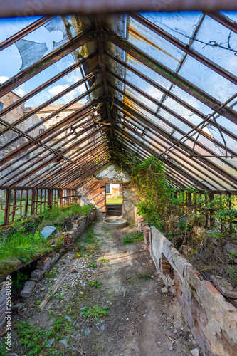 Look to old ruined greenhouse. Broken ancient greenhouse with broken windows