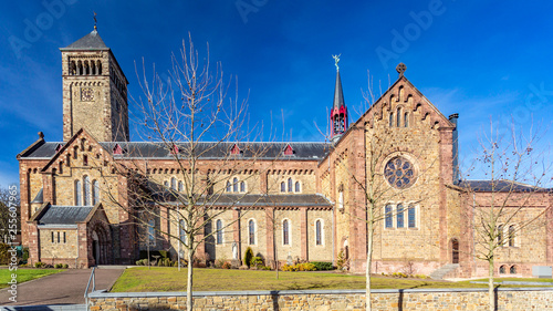 Beautiful side view of a church with its clock in a tower and multiple windows on a splendid sunny day with a blue sky in Beek South Limburg in the Netherlands Holland