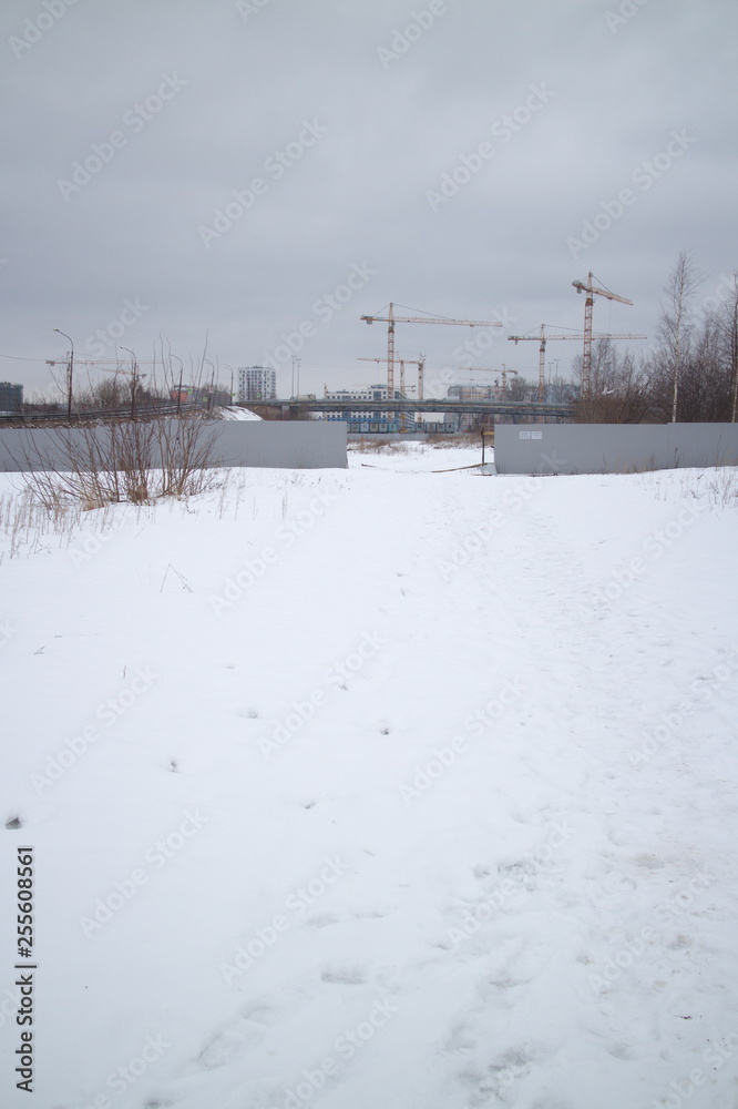 outskirts of the city next to new buildings on a winter day
