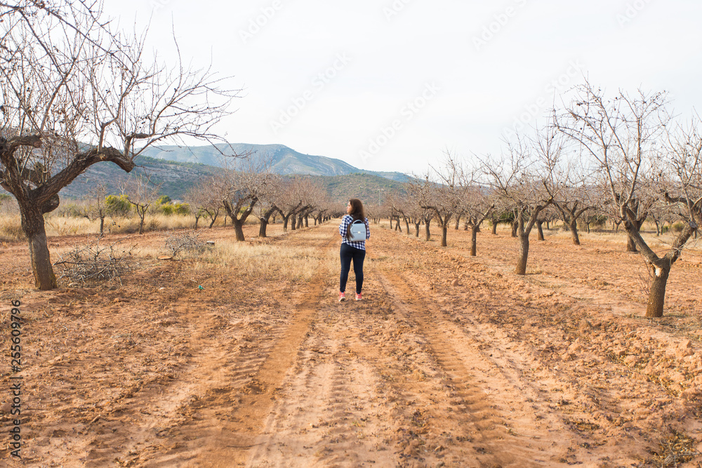 Holiday, travel and tourism concept - Young woman with stylish backpack on summer nature Holiday, travel and tourism concept - Young woman with stylish backpack on summer nature