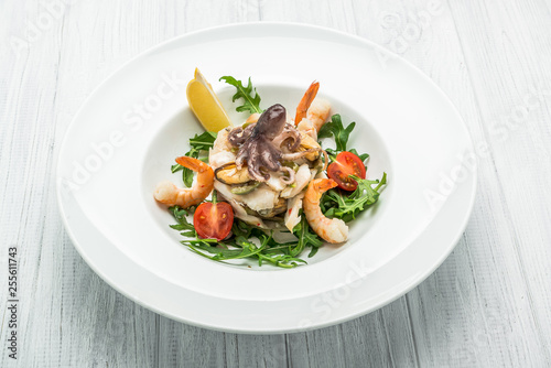 salad of seafood and vegetables with arugula and tomatoes