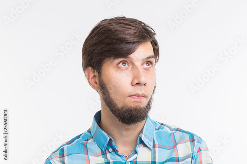 Process, problem, people concept - young man thinking about something on white background