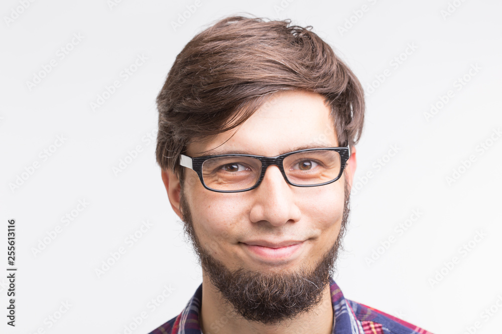 People and emotions concept - close up portrait of bearded young man in glasses on white background People and emotions concept - close up portrait of bearded young man in glasses on white background
