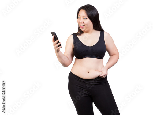 Fat woman squeeze belly fat looking at mobile phone face smile happy weight loss concept isolated on white background