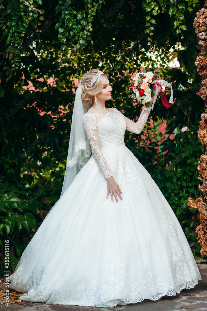 Portrait of a young beautiful bride with a bouquet