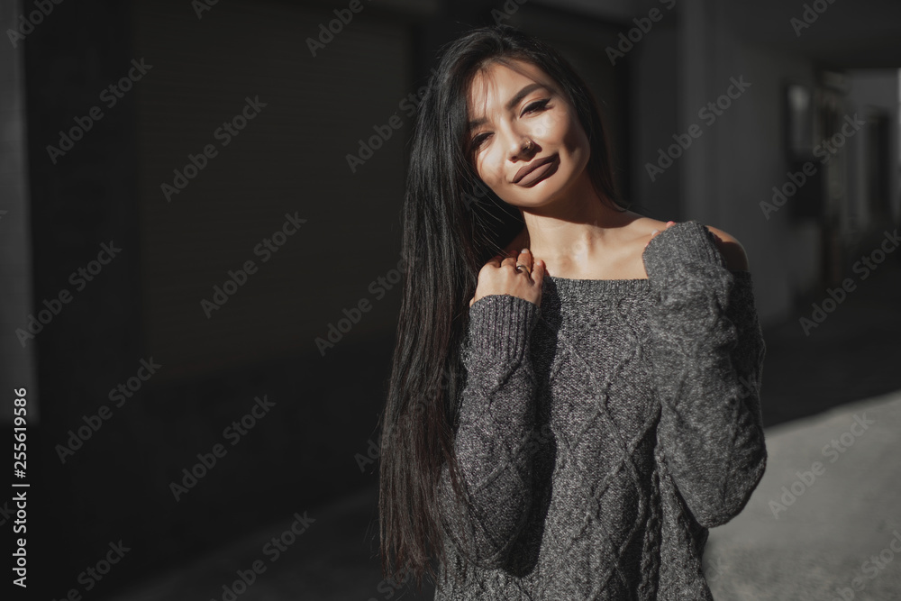 Beautiful model poses for the camera on the streets. Beautiful model poses for the camera on the streets.