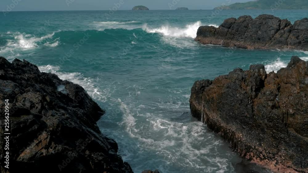 Slow motion shot of big sea waves crashing against the rocks. Waves crashing and hitting on the rocks at the sea. Palawan island, Philippines. Beautiful scenic nature landscape. S Travel concept. Slow motion shot of big sea waves crashing against the rocks. Waves crashing and hitting on the rocks at the sea. Palawan island, Philippines. Beautiful scenic nature landscape. S Travel concept.