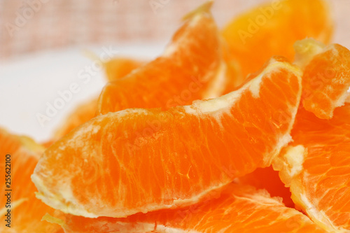 Slice of fresh orange fruit. Macro shoot of fresh orange. Orange background