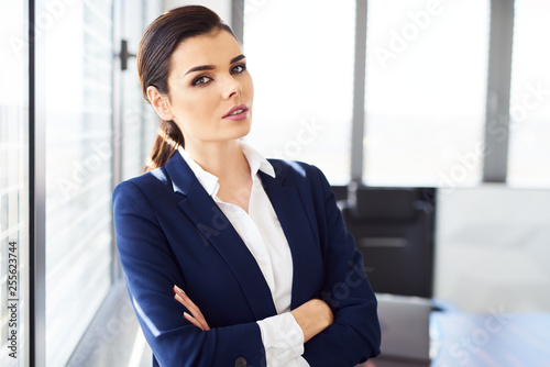 Portrait of confident businesswoman standing in modern office