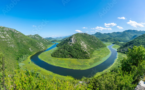 The picturesque meandering river flows among green mountains.