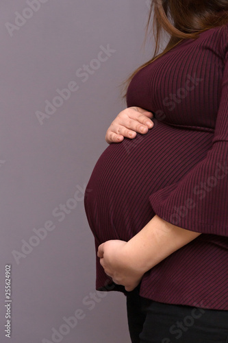 Expectant Mom Holding Her Budding Baby Bump