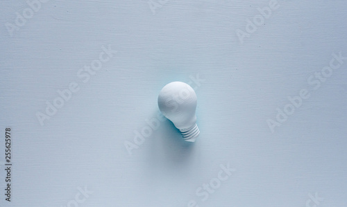 Light bulb painted with paint in pastel background. Creative idea concept. 