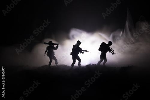 Military soldier silhouette with gun. War Concept. Military silhouettes fighting scene on war fog sky background, World War Soldier Silhouette Below Cloudy Skyline At night.