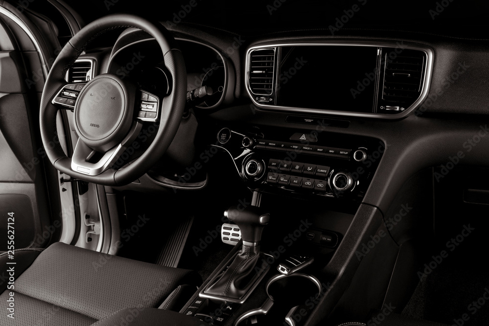 Modern car interior, automatic gearbox, steering wheel, and dashboard