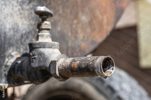 old rusty water tap from a barrel