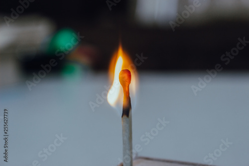 a lit match on a light background