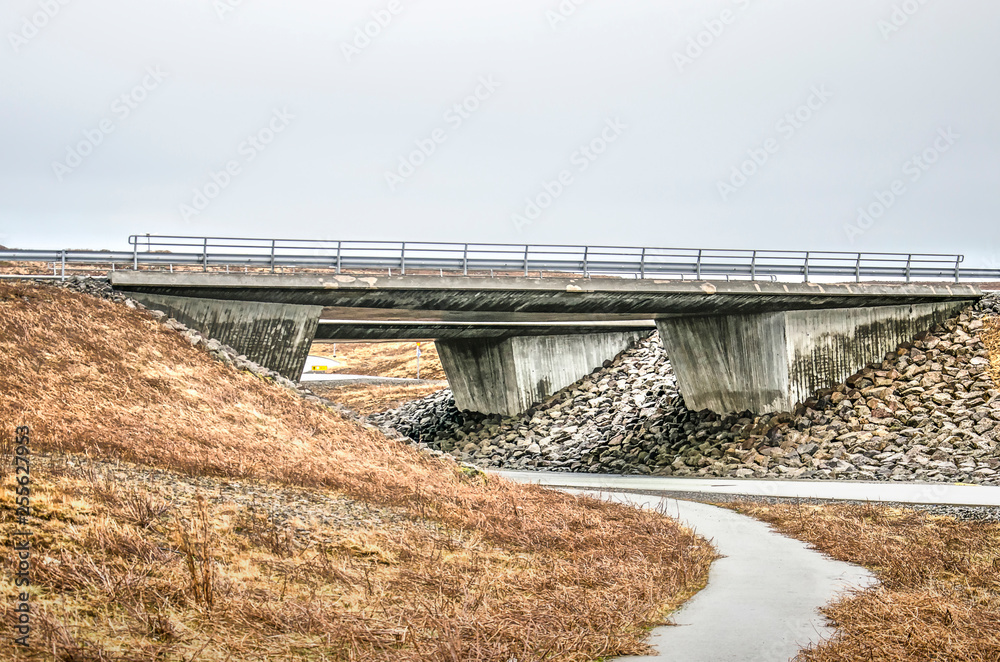 Robust concrete viaduct in a highway near Reykjavik, Iceland, with a secondary road passing underneath Robust concrete viaduct in a highway near Reykjavik, Iceland, with a secondary road passing underneath