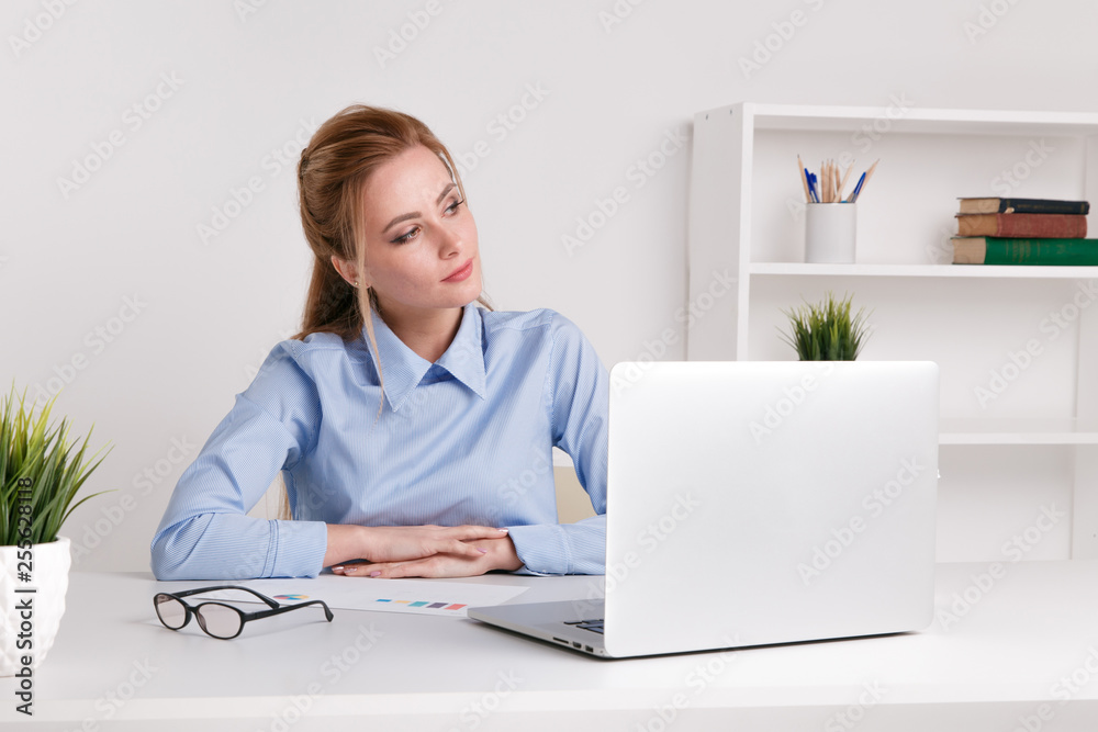 Nice blonde woman sittin at her workplace and thinking about her deals. Nice blonde woman sittin at her workplace and thinking about her deals.