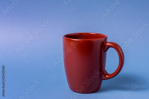 Brown big mug isolated on blue background.