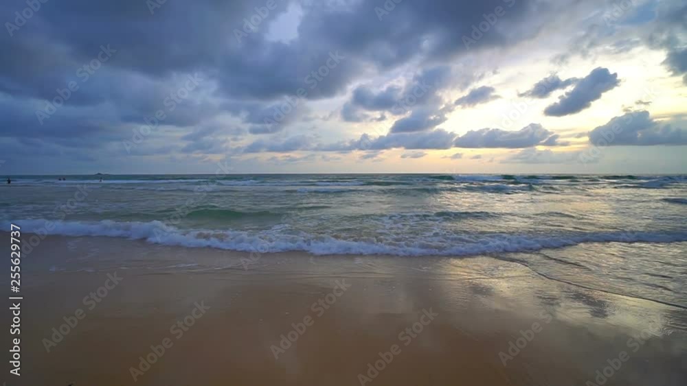 Relaxing beach scene background, sun setting over calm warm waves