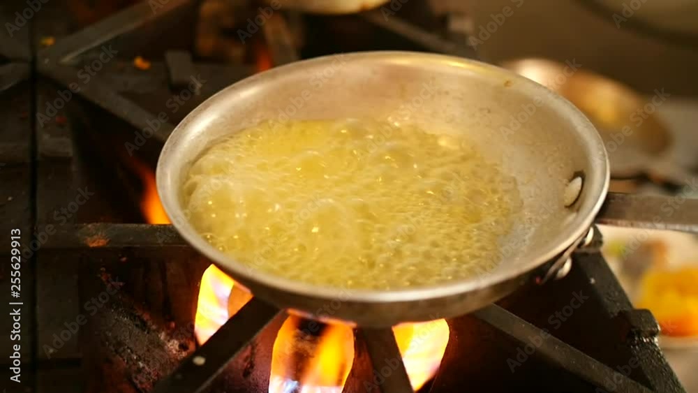 A butter-based glaze is cooked on a frying pan. A butter-based glaze is cooked on a frying pan.