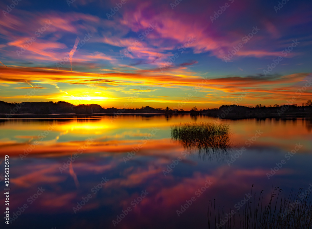 A beautiful sunset at a calm and peaceful lake - colorful sky