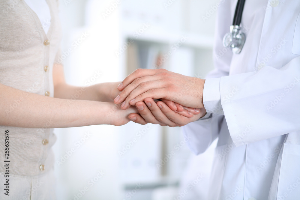 Hand of doctor reassuring her female patient. Medicine and health care concept Hand of doctor reassuring her female patient. Medicine and health care concept