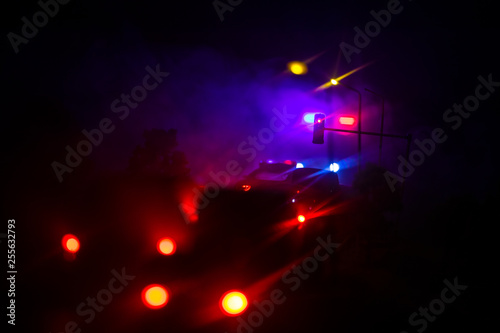 lighting of police car in the night during accident on the road. Artwork table decoration.