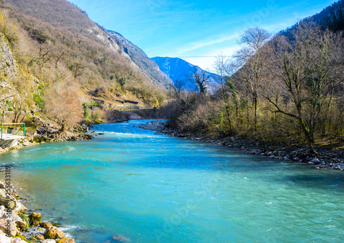 Beautiful mountain river with turquoise color water flowing down the gorge