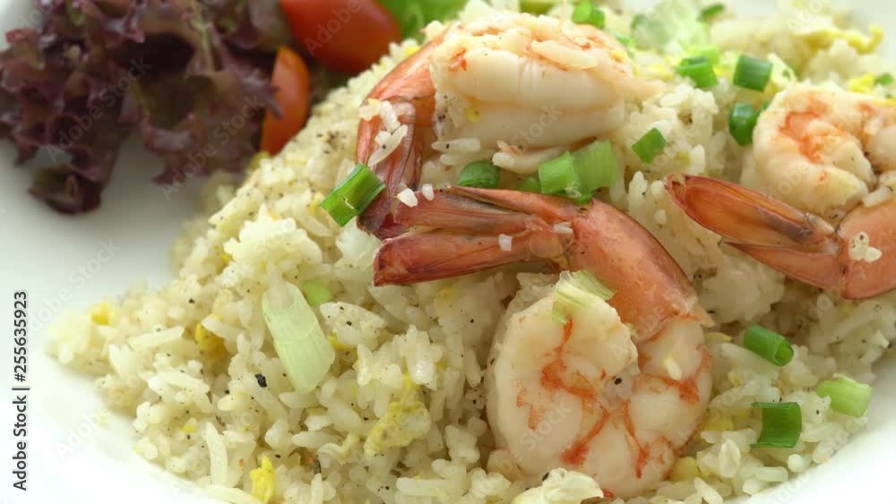 A freshly made prawn and rice dish served with salad. A freshly made prawn and rice dish served with salad.