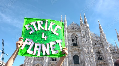 Picket sign for global strike for climate day, Duomo building, cathedral square, Milan, Italy. Friday for future, Greta Thunberg ecological movement, placard environmental activism 