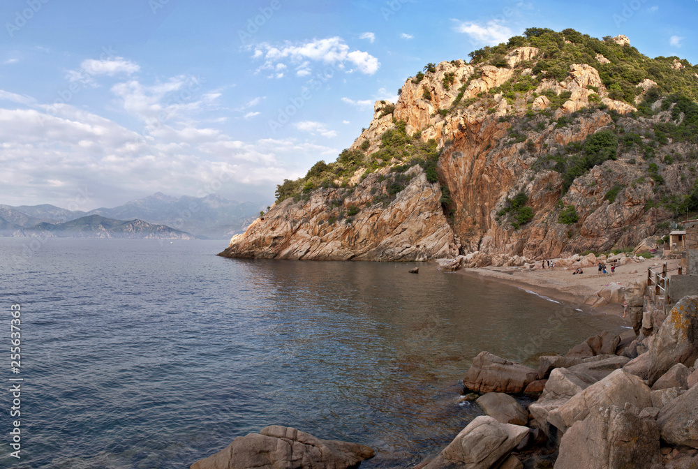 Small sandy beach hidden between rocks on Corsica island