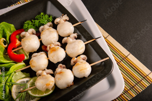 Baby cuttlefish grill on a wooden skewer