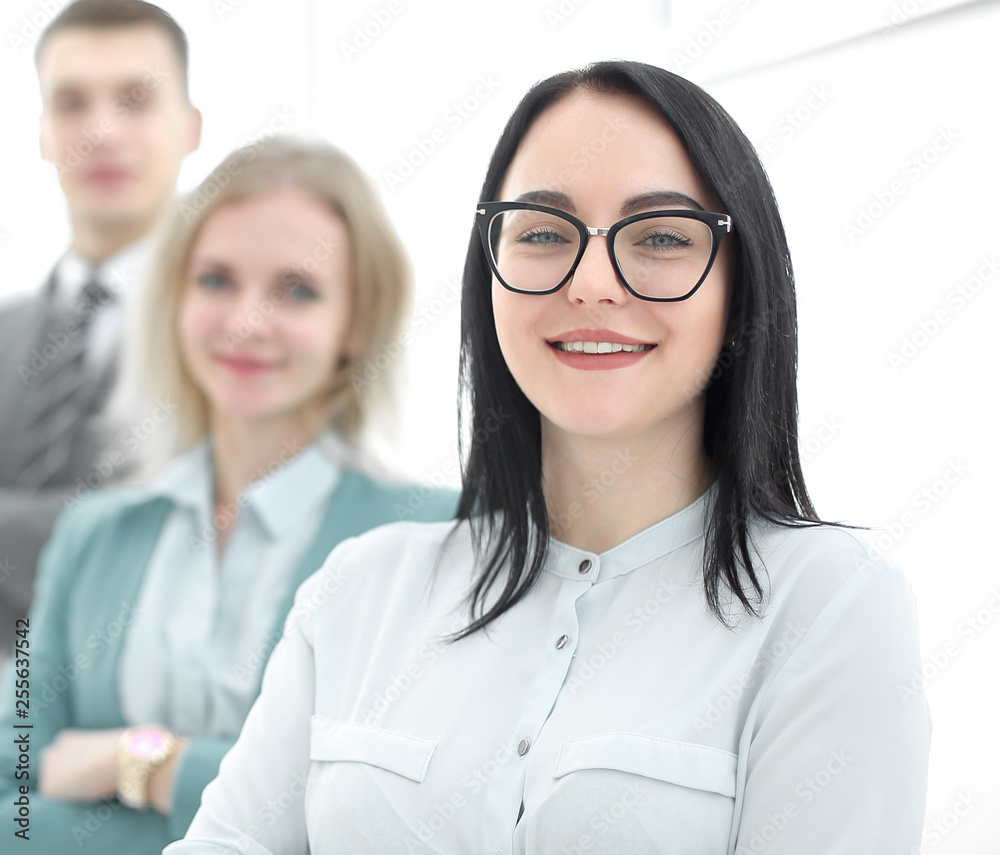 confident businesswoman standing in front of his business team