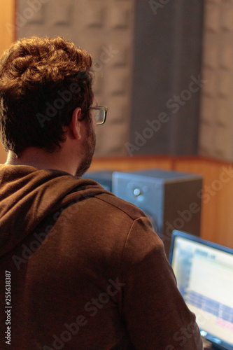 man working in recording studio with laptop