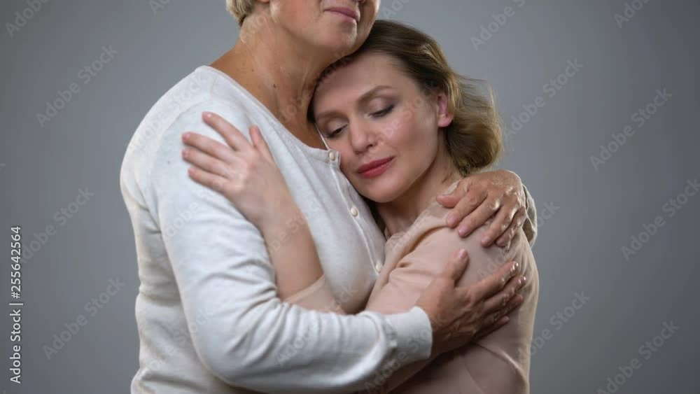 Senior lady hugging adult daughter, parenthood feeling, family understanding Senior lady hugging adult daughter, parenthood feeling, family understanding