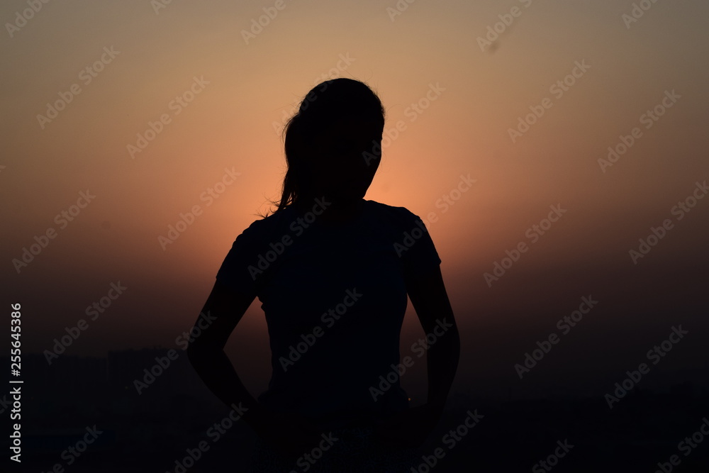 silhouette of a woman in sunset