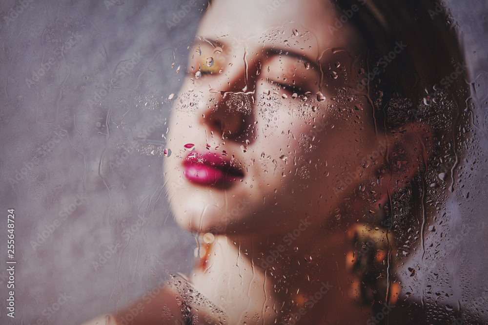 woman with makeup and earring with rain drops