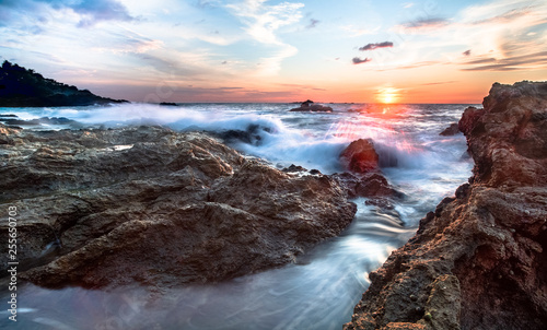 Long exposure at sunset of waves crashing on the west side of the Osa Peninsula, Costa Rica. photo