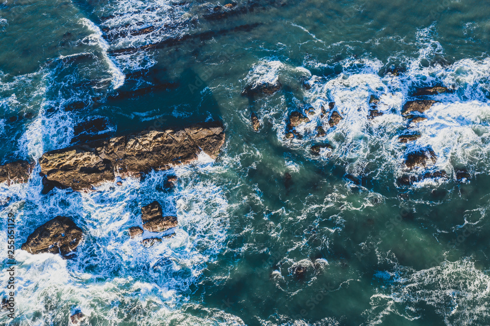 Dramatic ocean waves photographed top down with  a drone