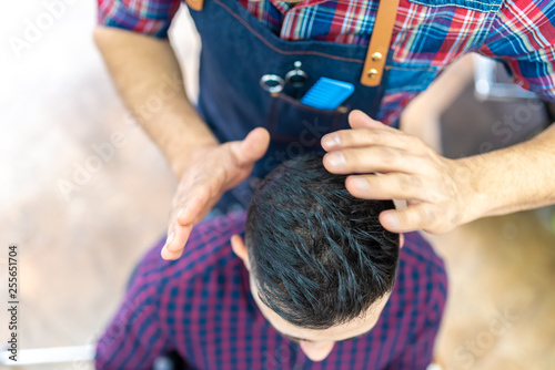 Young Man Getting a Hairstyle in a Barbershop.