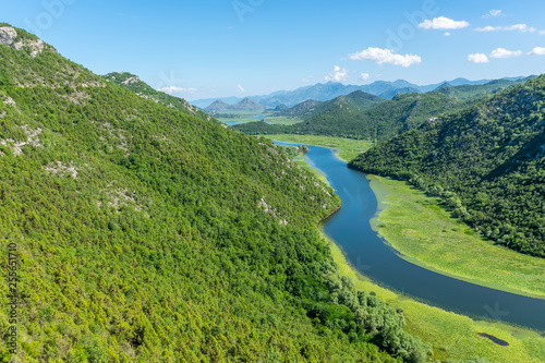 The picturesque meandering river flows among green mountains.