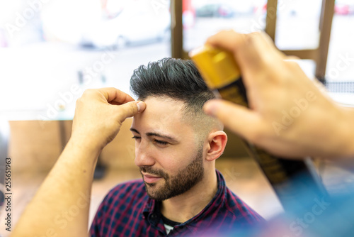 Young Man Getting a Hairstyle in a Barbershop.