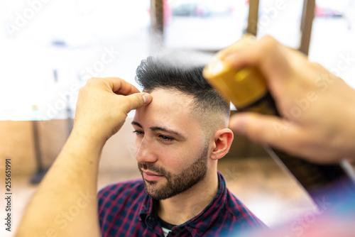 Young Man Getting a Hairstyle in a Barbershop.